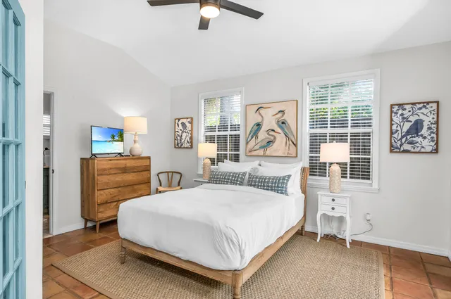 a bedroom with a bed and a painting on the wall