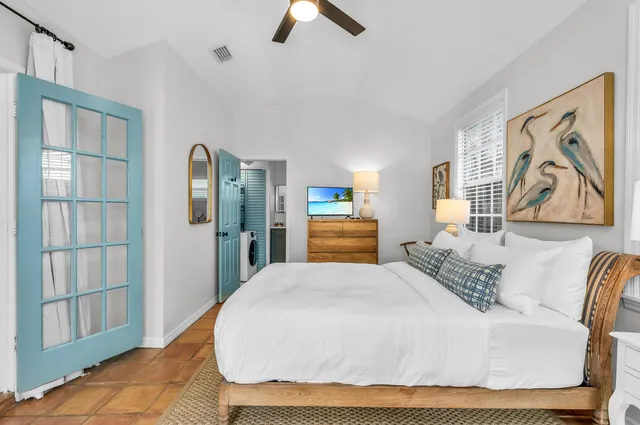 a bedroom with a bed and a large window