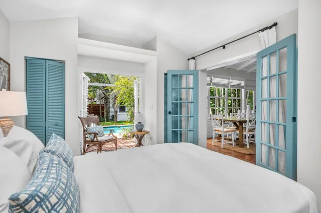 a view of swimming pool with chairs and potted plants