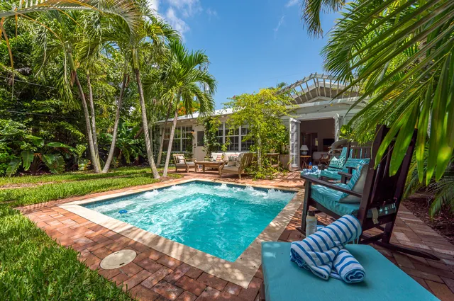 a view of a backyard with sitting area