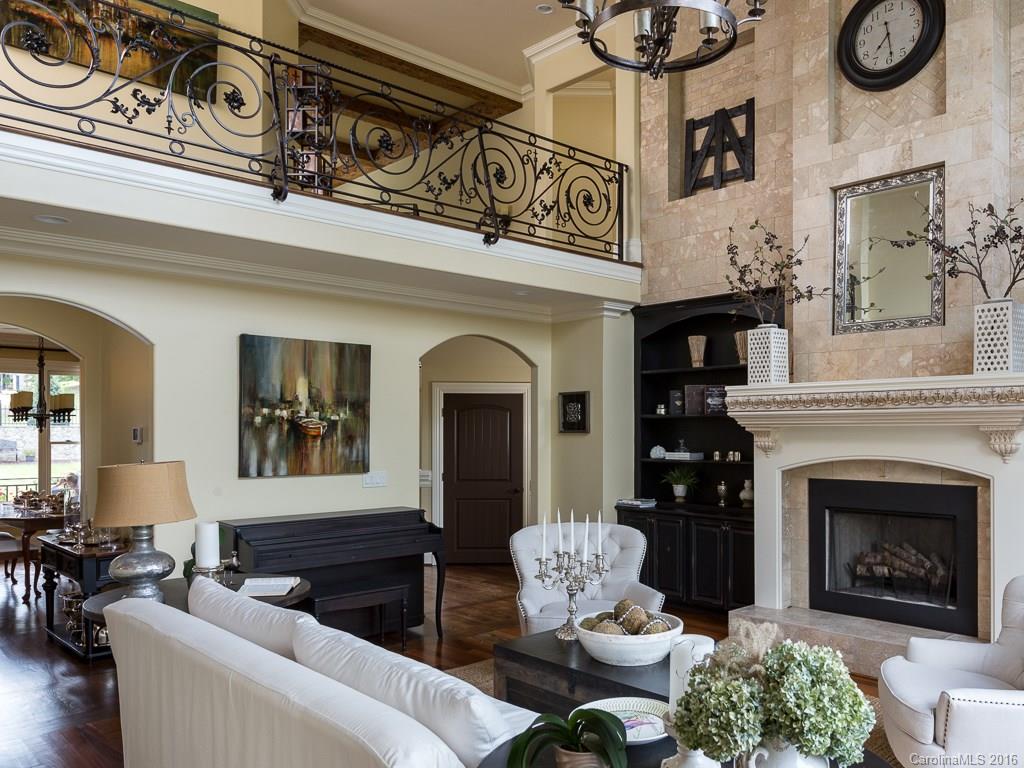 7099 Anchorage Lane Tega Cay, SC 29708 - Photo 2 of 24 a living room with furniture a fireplace and wall paintings