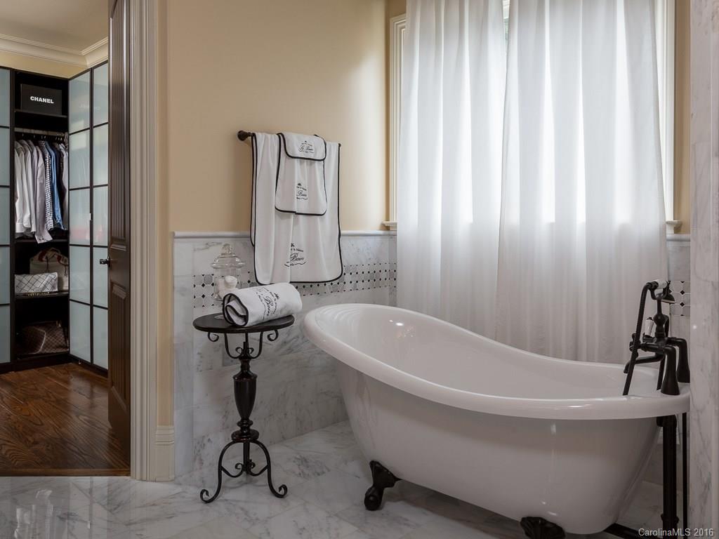 7099 Anchorage Lane Tega Cay, SC 29708 - Photo 11 of 24 a bathroom with a tub and a shower