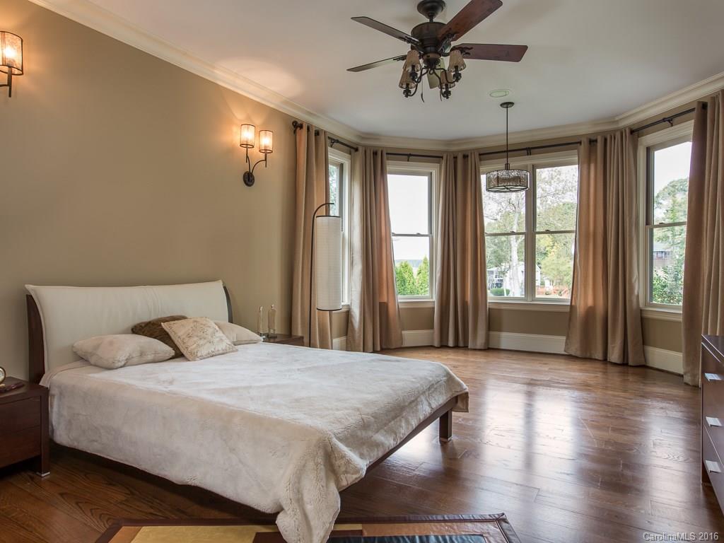 7099 Anchorage Lane Tega Cay, SC 29708 - Photo 14 of 24 a bedroom with a large bed and wooden floor