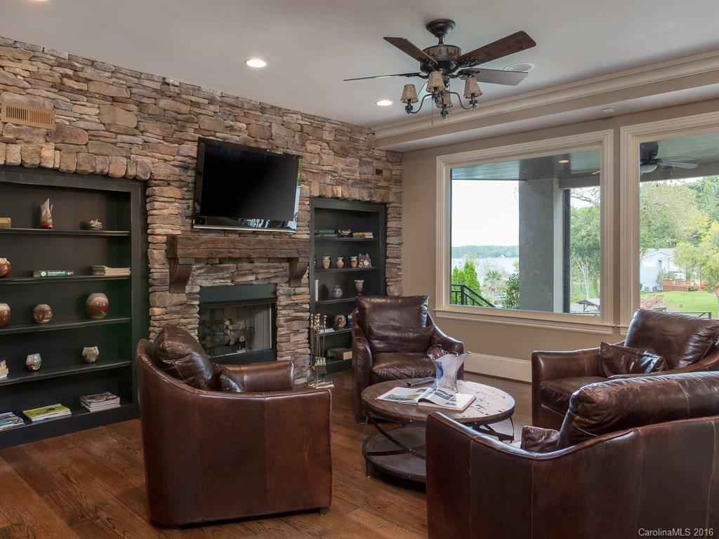 7099 Anchorage Lane Tega Cay, SC 29708 - Photo 20 of 24 a living room with furniture a flat screen tv and a fireplace