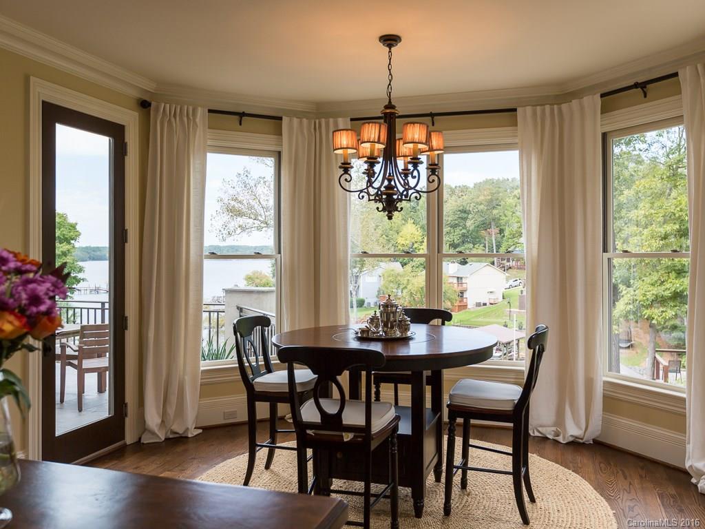 7099 Anchorage Lane Tega Cay, SC 29708 - Photo 5 of 24 a view of a dining room with furniture window and wooden floor