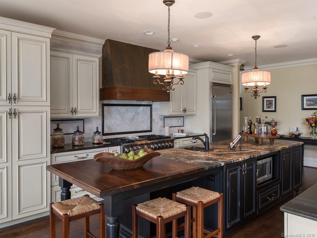 7099 Anchorage Lane Tega Cay, SC 29708 - Photo 6 of 24 a kitchen with a table chairs and white cabinets