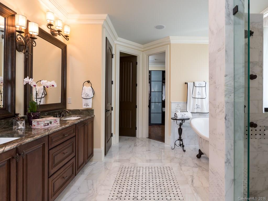 7099 Anchorage Lane Tega Cay, SC 29708 - Photo 10 of 24 a bathroom with a double vanity sink a mirror and a shower