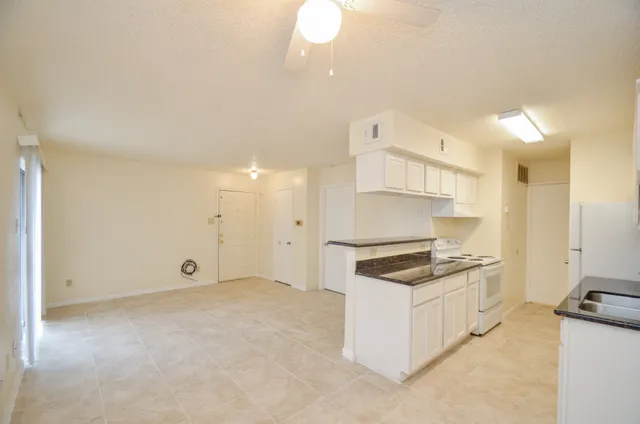 a kitchen with granite countertop a stove and a sink