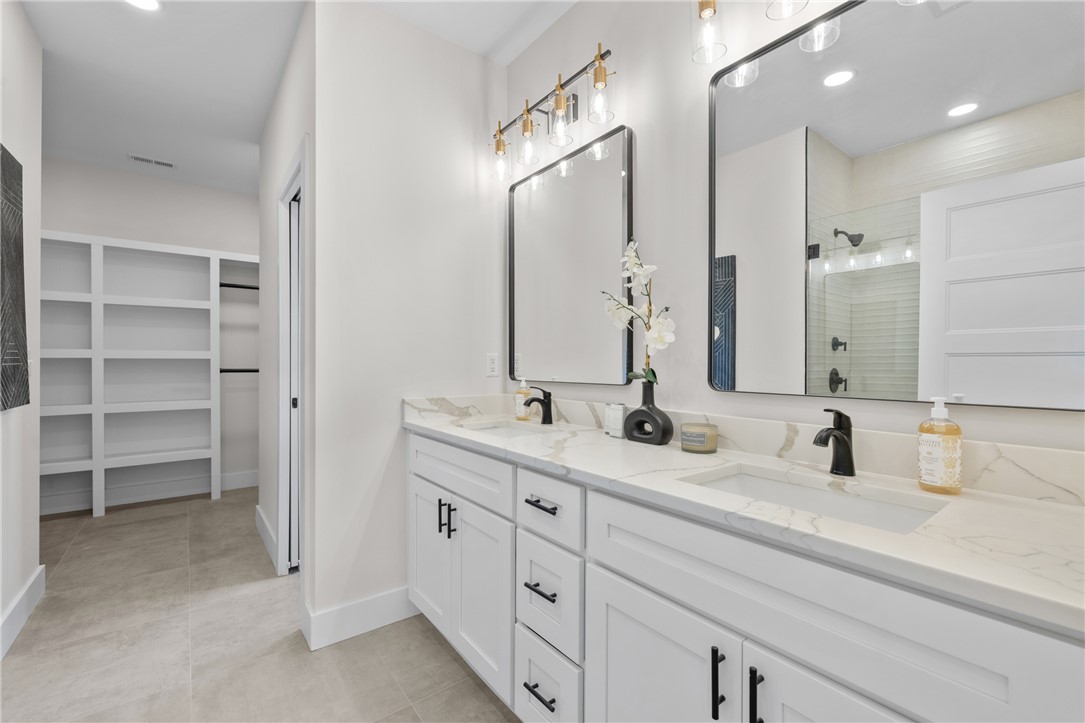 502 Point Road Westminster, SC 29693 - Photo 17 of 45 This modern bathroom features a double vanity and sleek fixtures, offering both style and convenience.