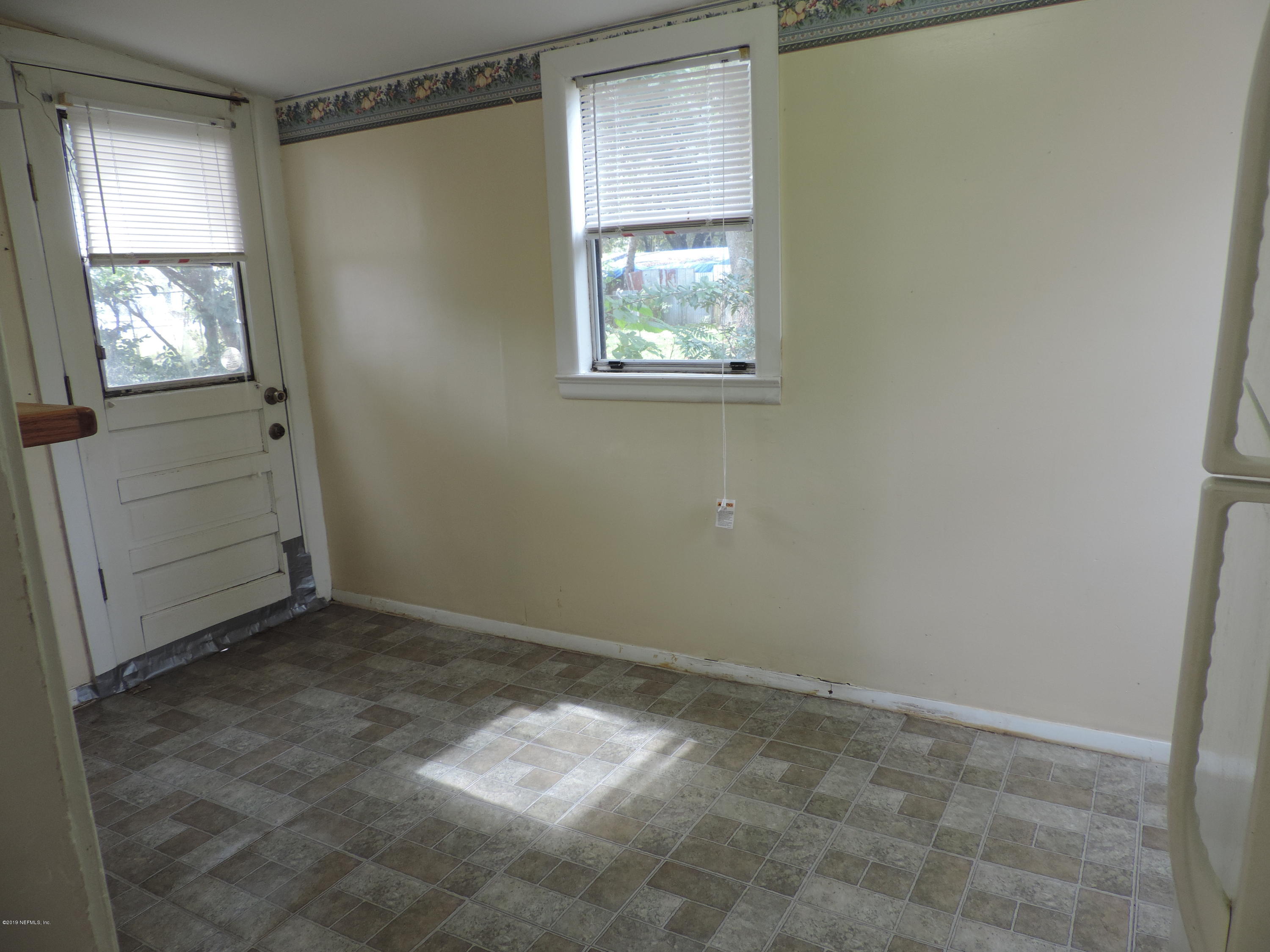 4244 Muncy Road Jacksonville, FL 32207 - Photo 12 of 19 an empty room with windows