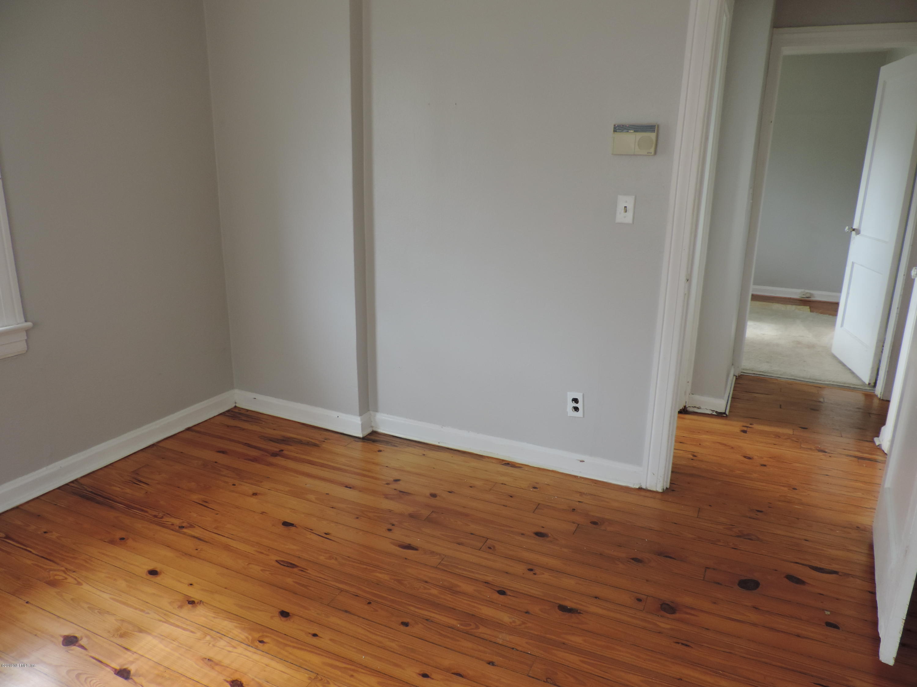 4244 Muncy Road Jacksonville, FL 32207 - Photo 17 of 19 wooden floor and empty room