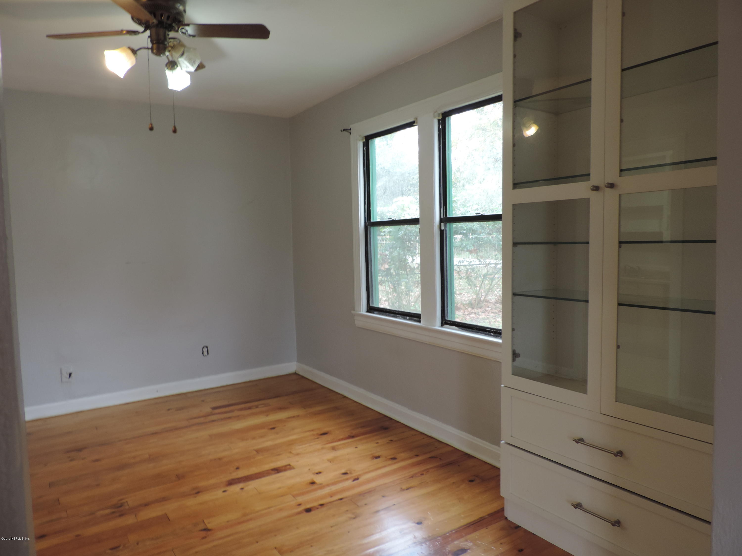 4244 Muncy Road Jacksonville, FL 32207 - Photo 7 of 19 wooden floor in an empty room with a window