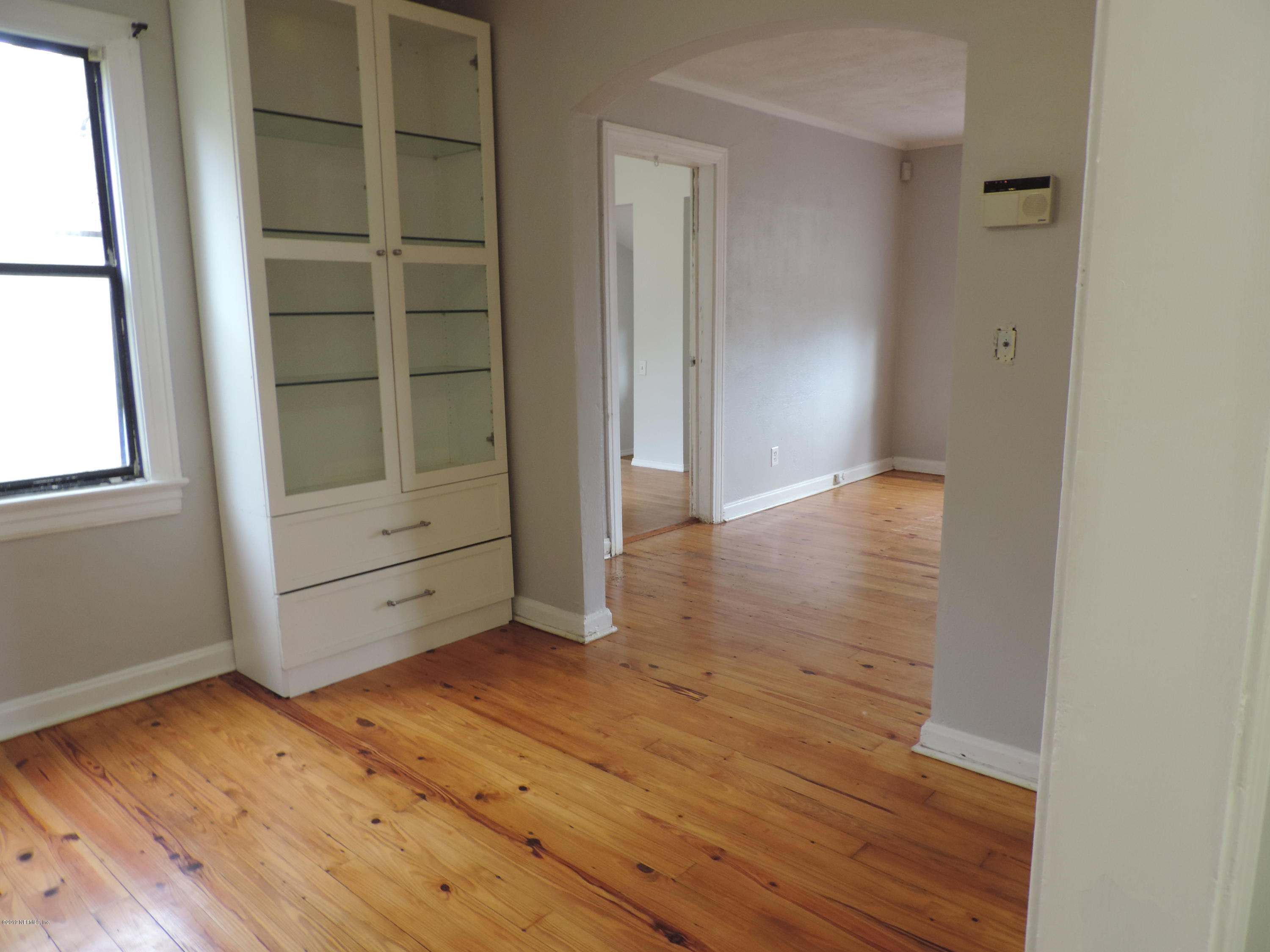 4244 Muncy Road Jacksonville, FL 32207 - Photo 8 of 19 a view of an empty room with wooden floor and closet