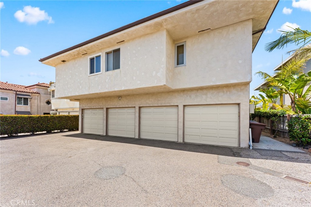 34381 Dana Strand Road, Unit 2 Dana Point, CA 92629 - Photo 32 of 32 a front view of a house with a yard and garage