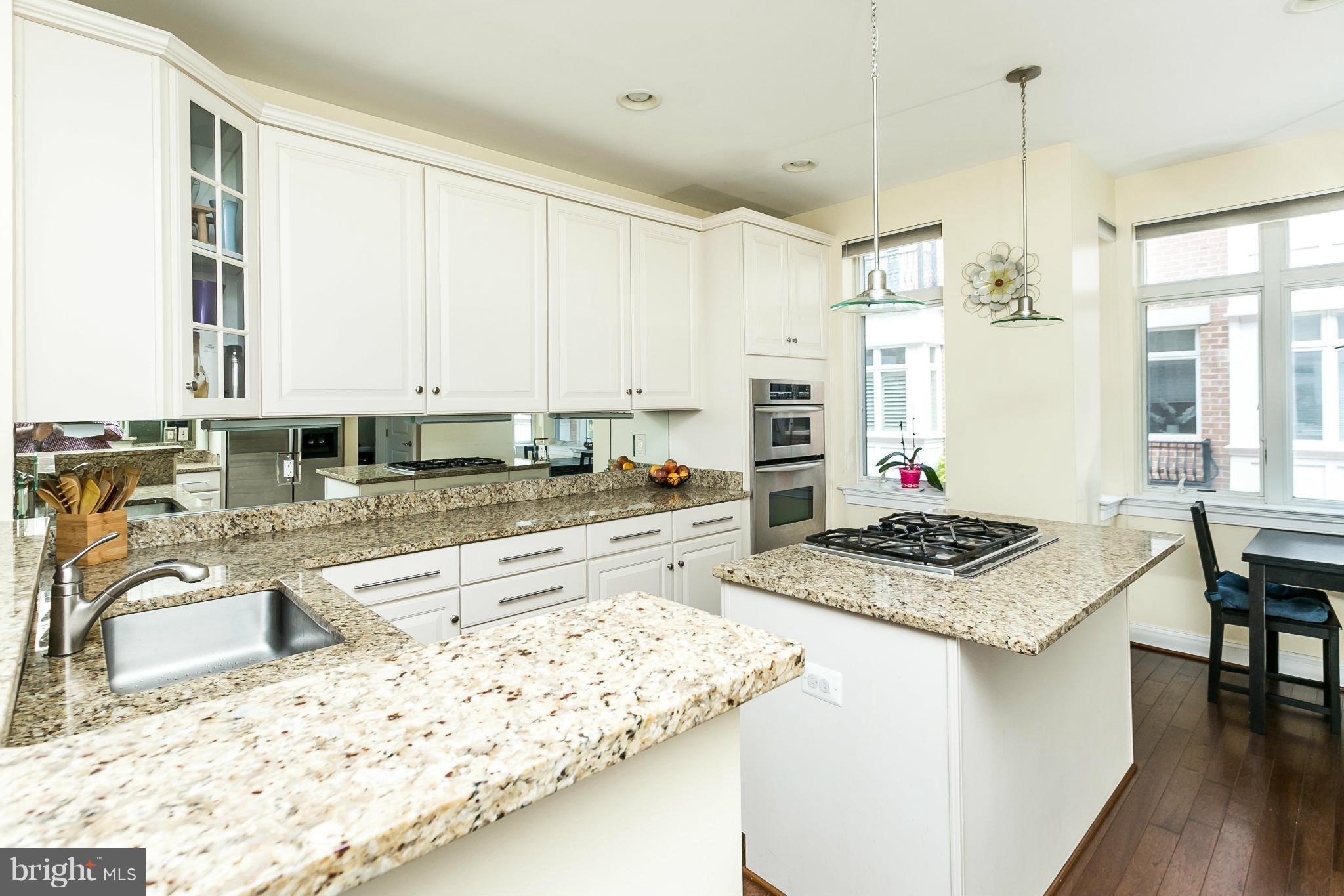 639 Ponte Villas South, Unit 128 Baltimore, MD 21230 - Photo 12 of 46 a kitchen with stainless steel appliances granite countertop a stove a sink and a microwave