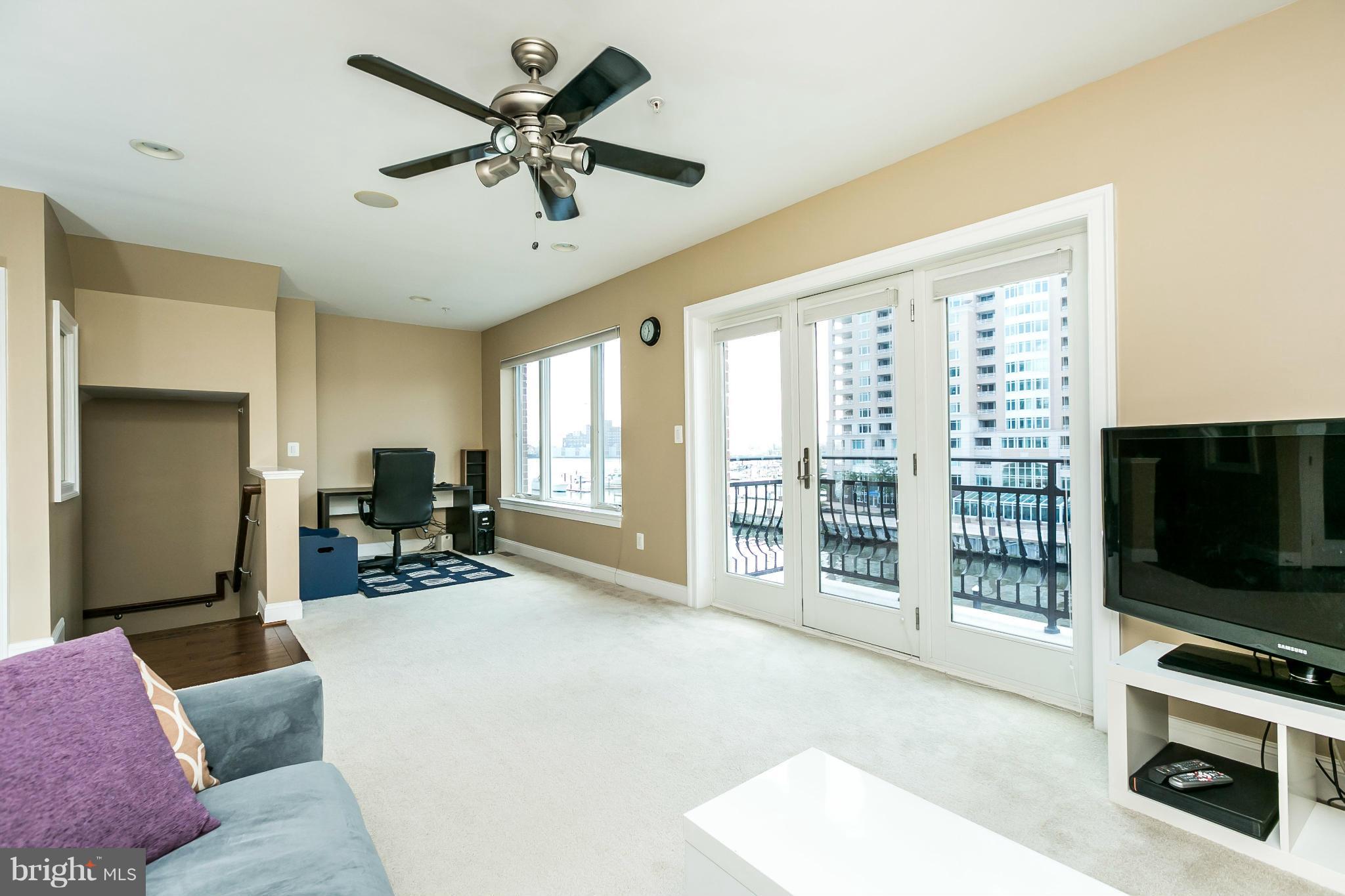 639 Ponte Villas South, Unit 128 Baltimore, MD 21230 - Photo 21 of 46 a living room with furniture a flat screen tv and a large window