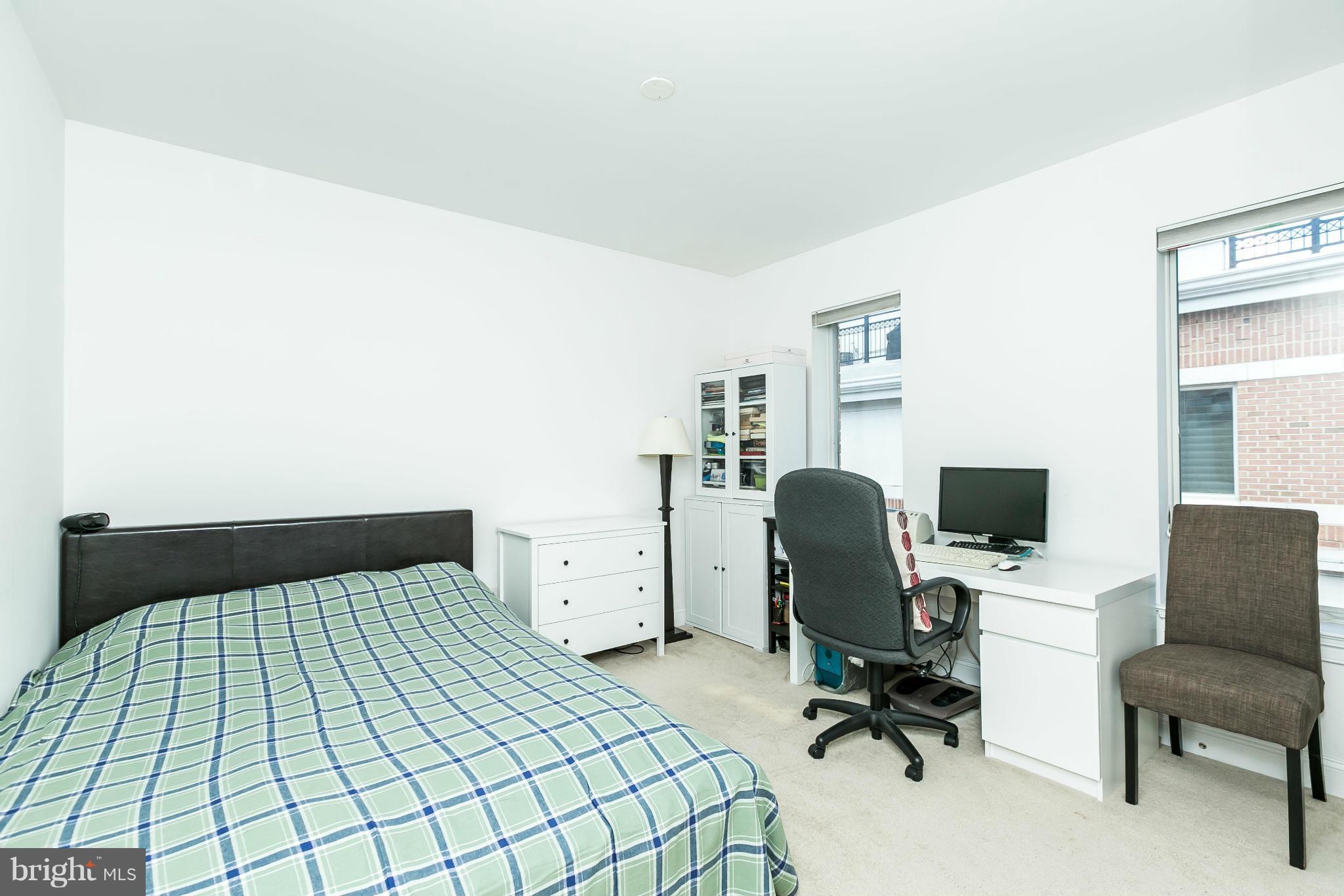 639 Ponte Villas South, Unit 128 Baltimore, MD 21230 - Photo 24 of 46 a bedroom with a bed and chair