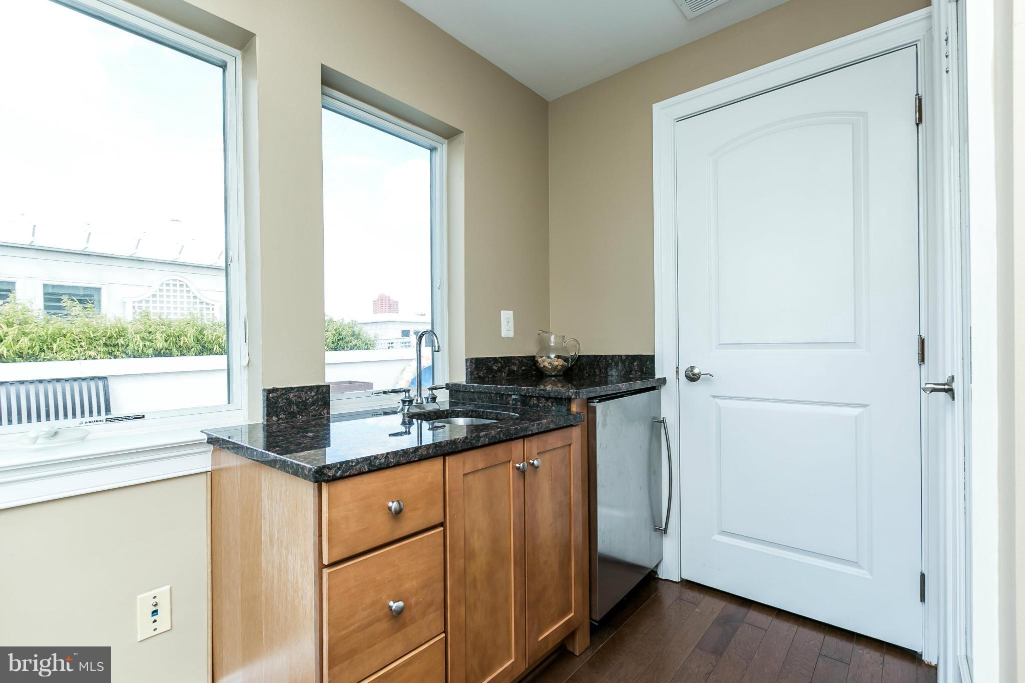 639 Ponte Villas South, Unit 128 Baltimore, MD 21230 - Photo 25 of 46 a kitchen with a sink and a window