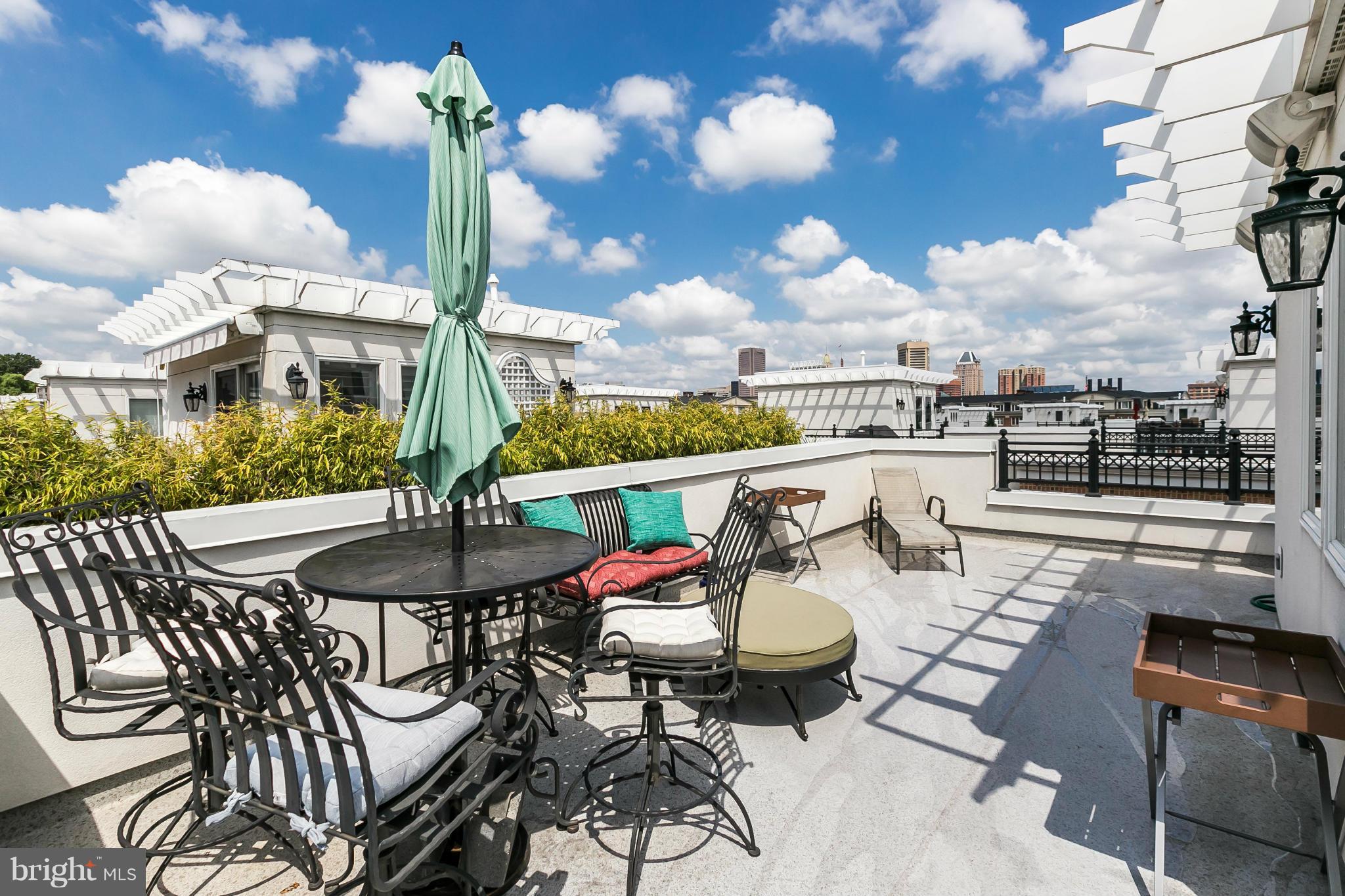 639 Ponte Villas South, Unit 128 Baltimore, MD 21230 - Photo 27 of 46 a view of a patio with table and chairs and potted plants