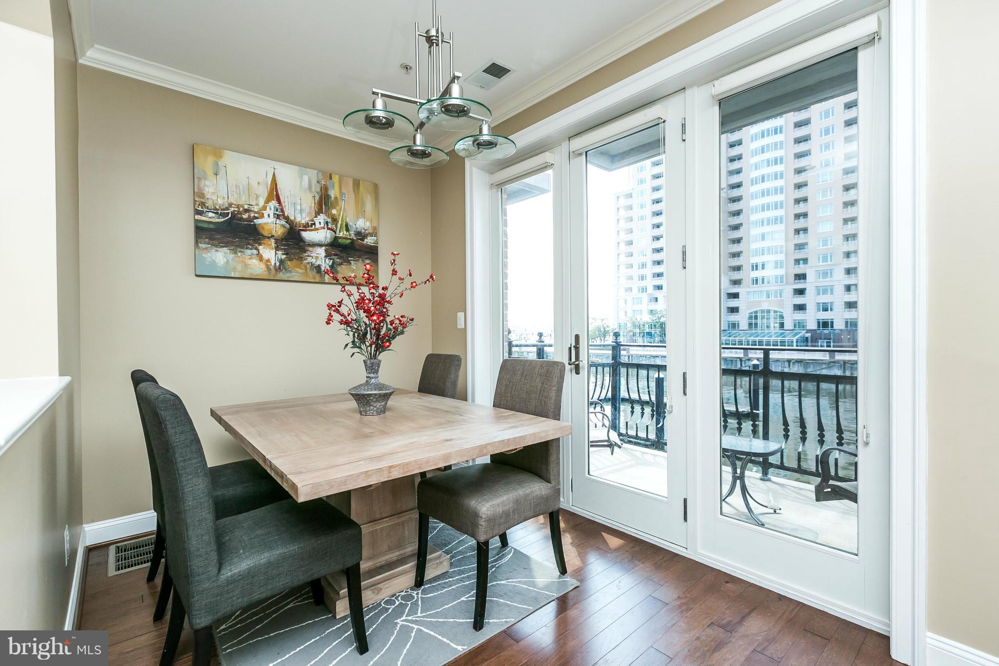 639 Ponte Villas South, Unit 128 Baltimore, MD 21230 - Photo 8 of 46 a view of a dining room with furniture wooden floor and chandelier