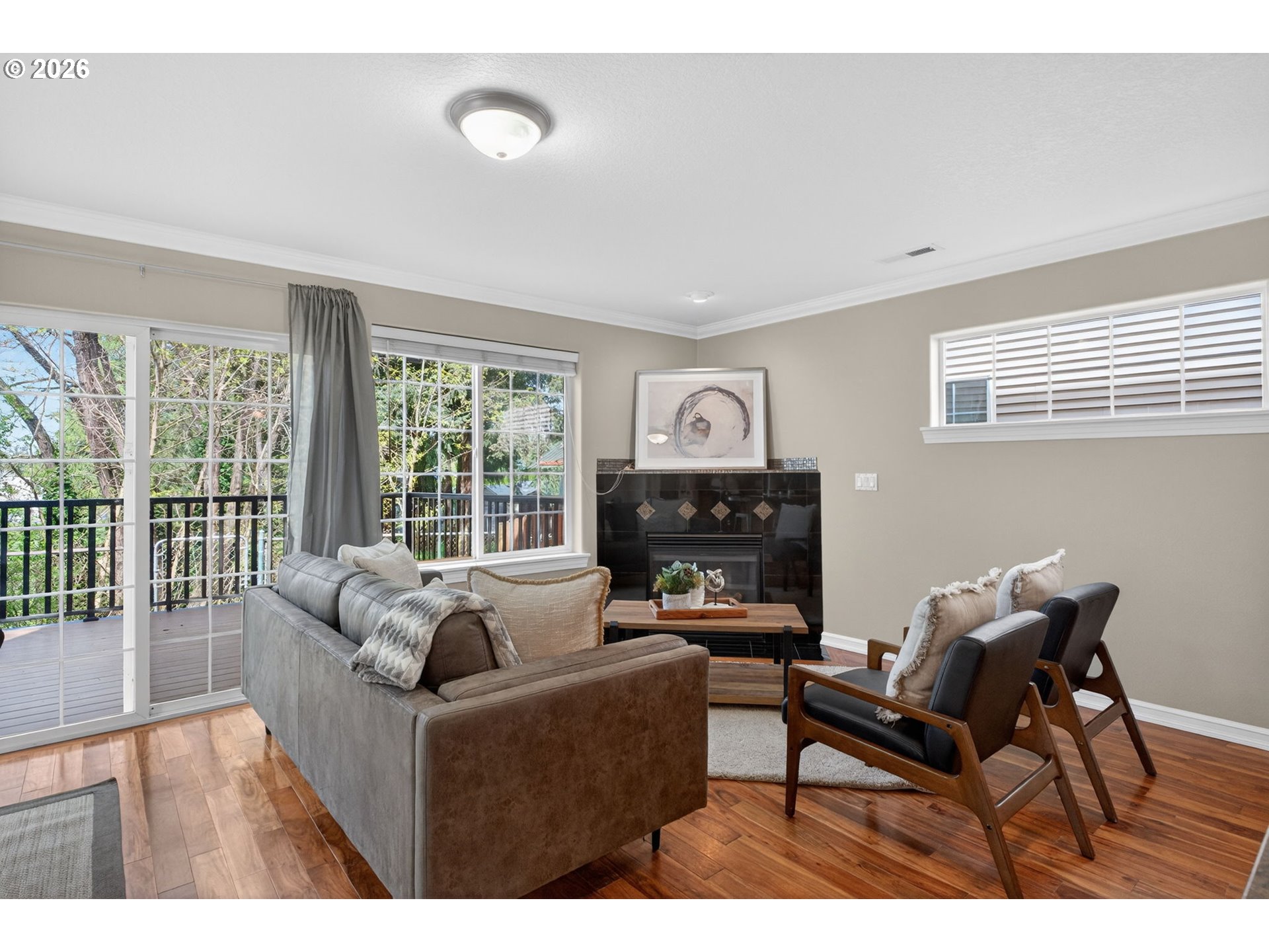 12619 Southeast Foster Road Portland, OR 97236 - Photo 19 of 48 a living room with furniture a fireplace and a floor to ceiling window