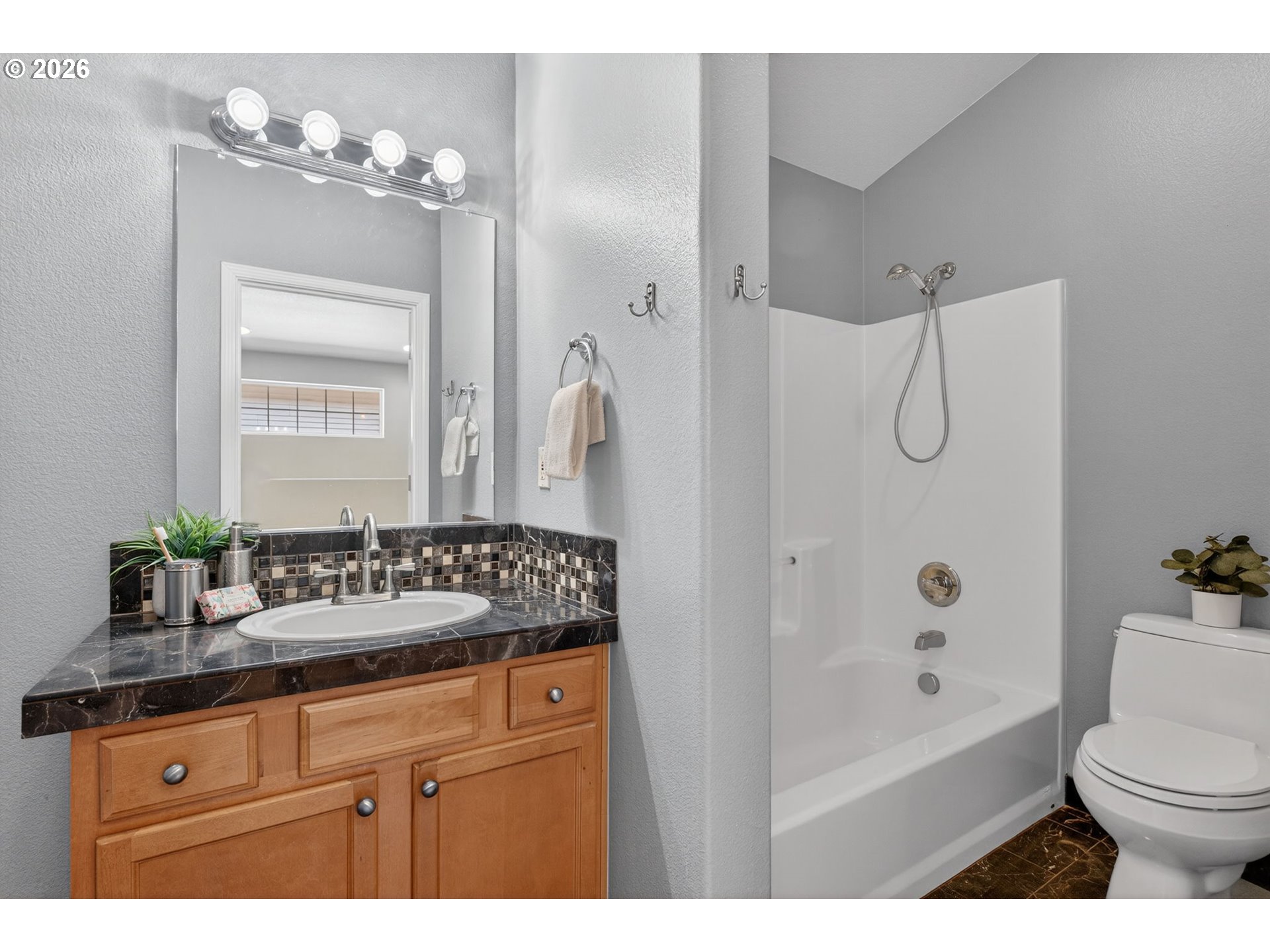 12619 Southeast Foster Road Portland, OR 97236 - Photo 32 of 48 a bathroom with a sink a toilet and shower