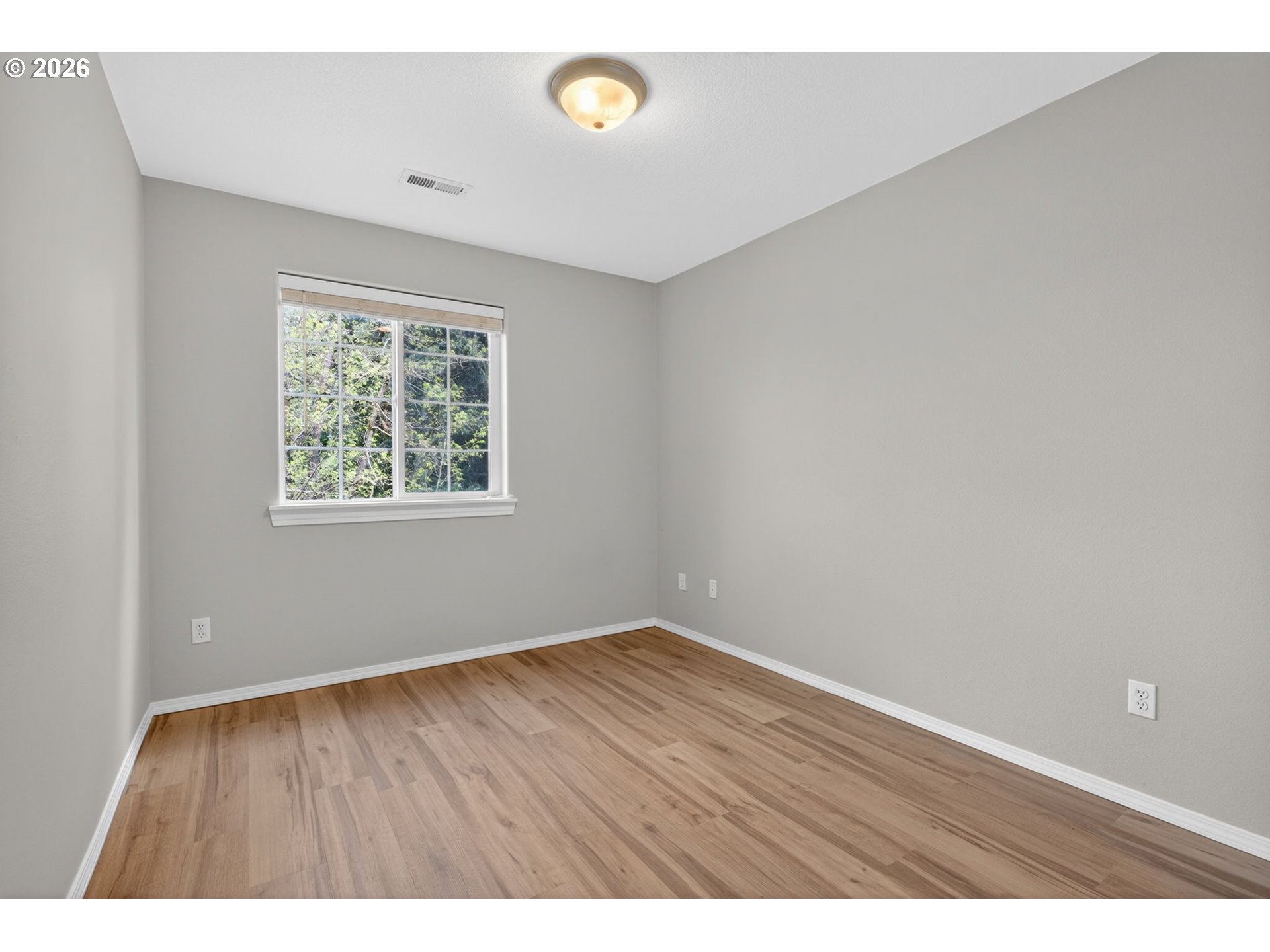 12619 Southeast Foster Road Portland, OR 97236 - Photo 34 of 48 an empty room with wooden floor and windows