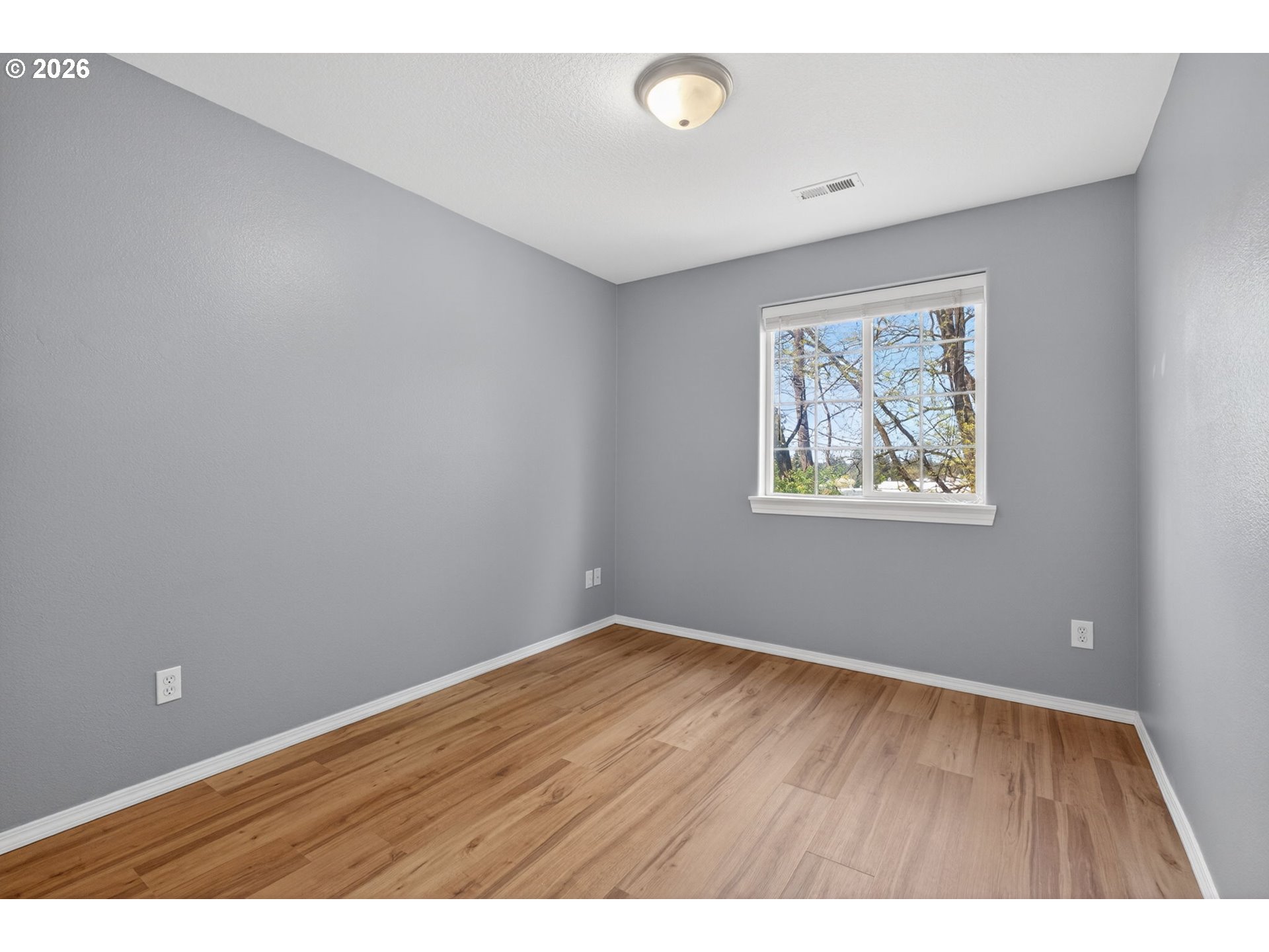 12619 Southeast Foster Road Portland, OR 97236 - Photo 37 of 48 a view of an empty room with wooden floor