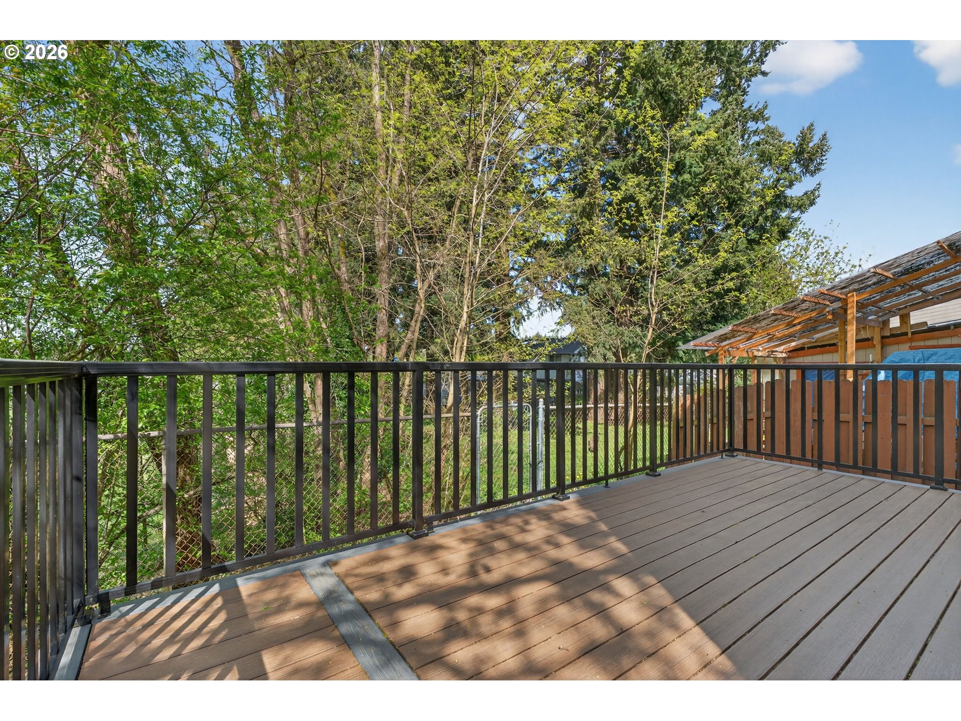 12619 Southeast Foster Road Portland, OR 97236 - Photo 38 of 48 a balcony with trees in front of it