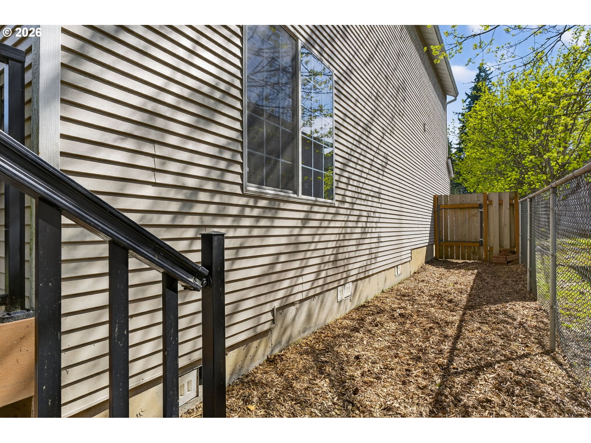 12619 Southeast Foster Road Portland, OR 97236 - Photo 41 of 48 a view of a backyard with plants and wooden fence
