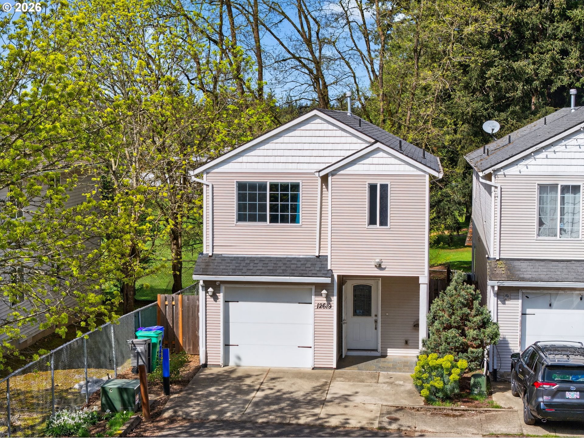 12619 Southeast Foster Road Portland, OR 97236 - Photo 46 of 48 a view of a white house with a small yard and large tree