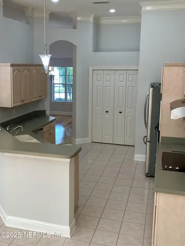 a kitchen with stainless steel appliances granite countertop a refrigerator a stove and a sink