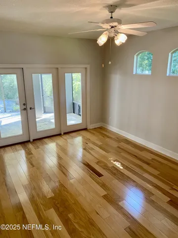 wooden floor in an empty room with a window