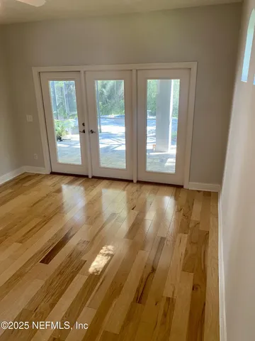 a view of wooden floor and windows in a room