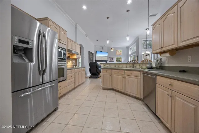 a kitchen with stainless steel appliances granite countertop a refrigerator sink and cabinets