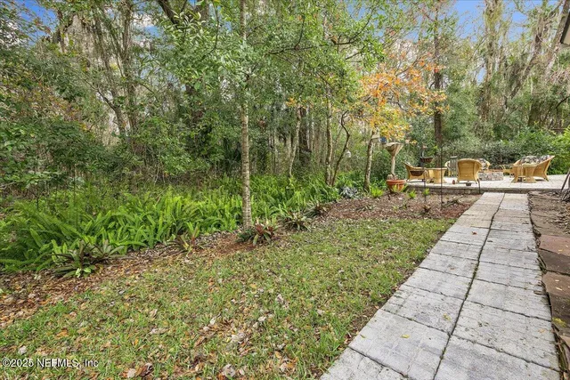 a view of a backyard with pathway