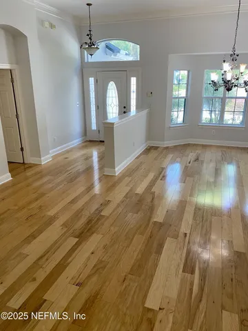 wooden floor in an empty room with a mirror