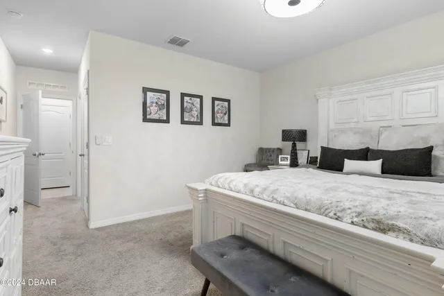 a bedroom with a bed and a couch