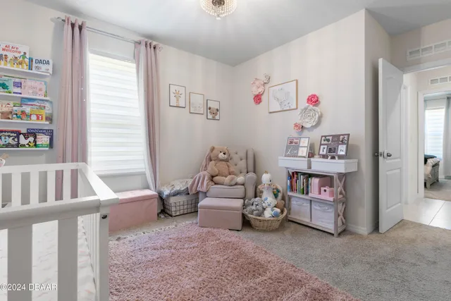 a view of a bedroom with baby crib