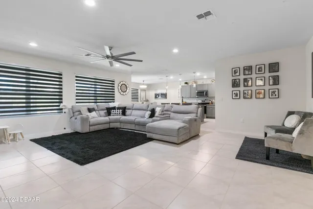 a living room with furniture two windows and a table