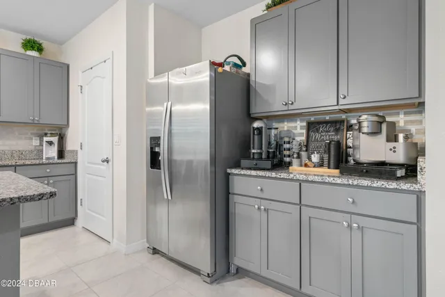 a kitchen with stainless steel appliances granite countertop a refrigerator and a stove
