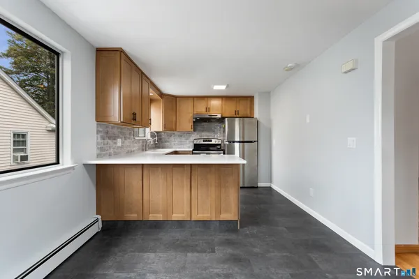 a kitchen with stainless steel appliances granite countertop a refrigerator sink and cabinets