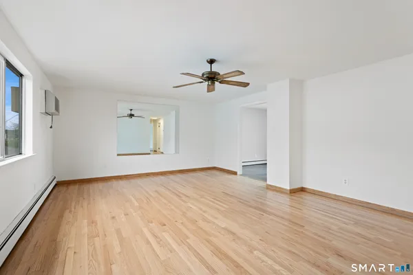 wooden floor in an empty room with a window