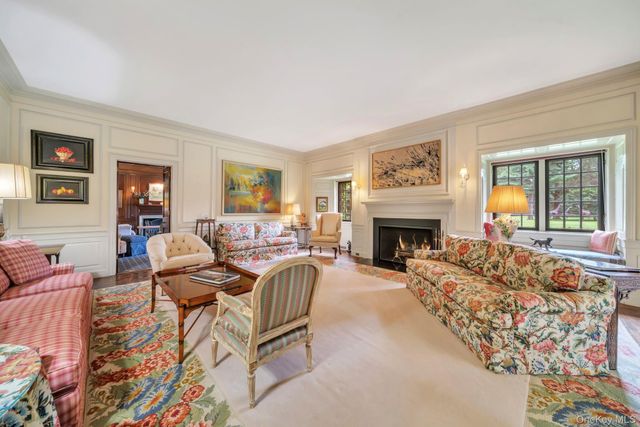 a living room with furniture large window and a fireplace