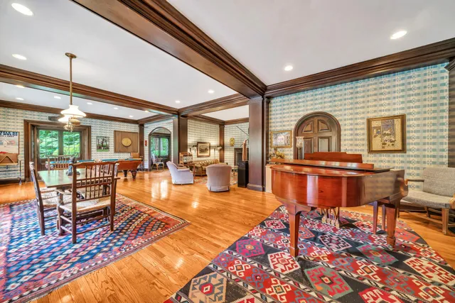 a living room with furniture a rug and a floor to ceiling window