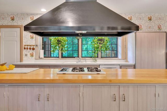 a kitchen with a stove and a large window