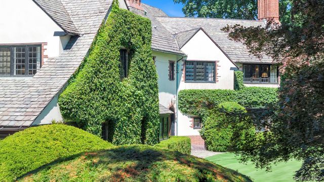 a aerial view of a house with a yard and plants