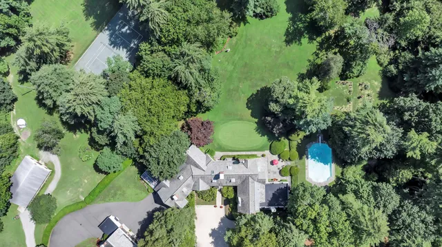 a view of a field of grass and trees