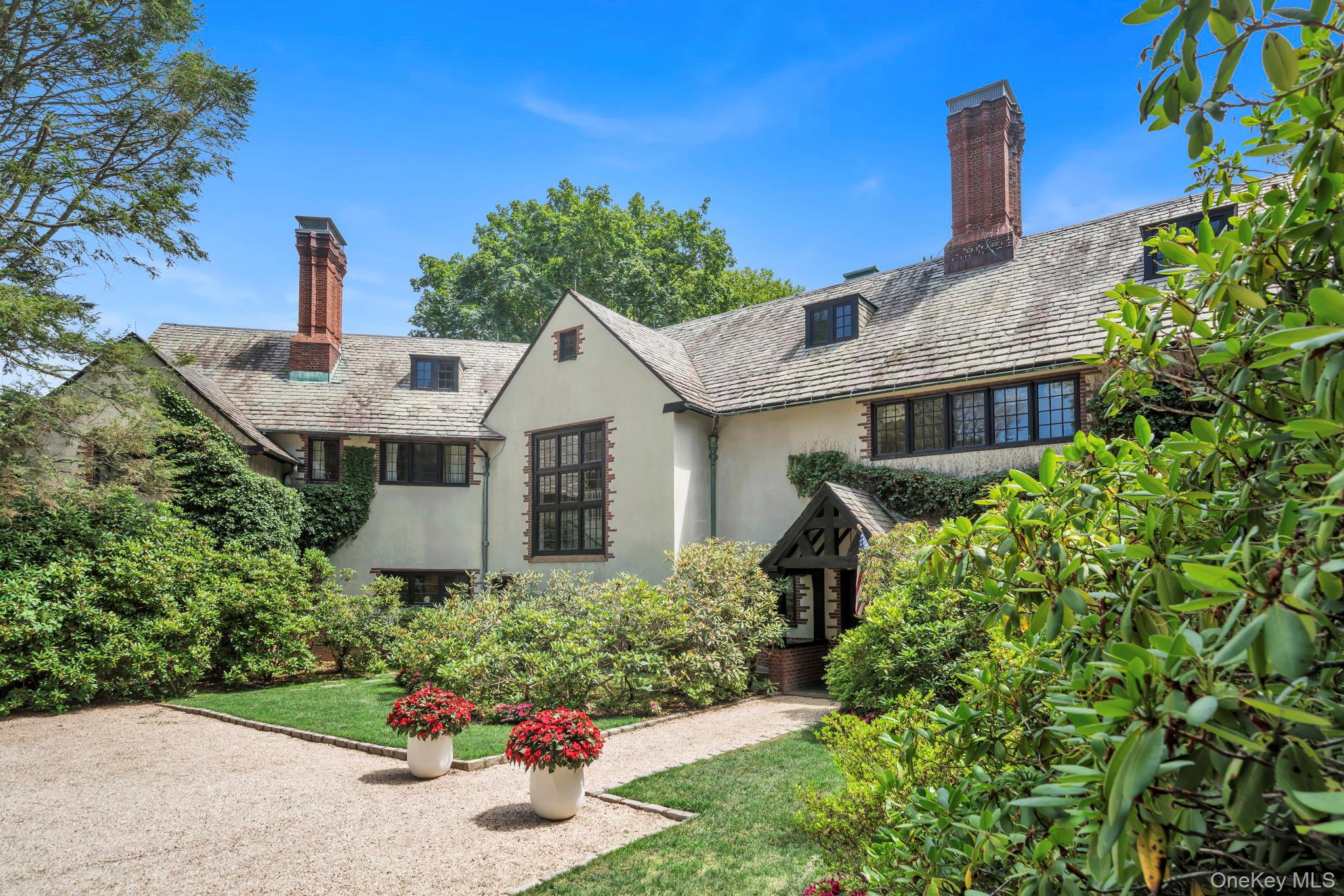 95 Piping Rock Road Locust Valley, NY 11560 - Photo 6 of 42 a front view of a house with a yard