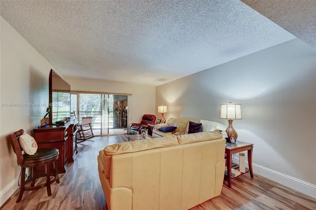a living room with furniture a window and a flat screen tv